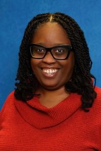 Keeshea Turner Headshot 300x200 Headshot of professor Keeshea Turner on a blue textured background